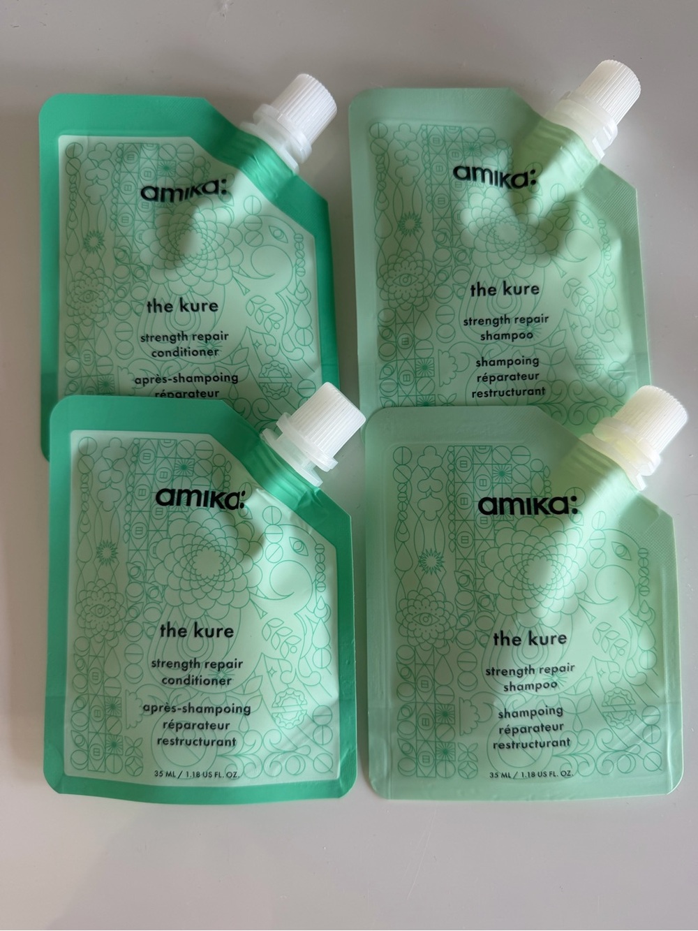 amika The Kure strength repair shampoo & conditioner pouches - mint green